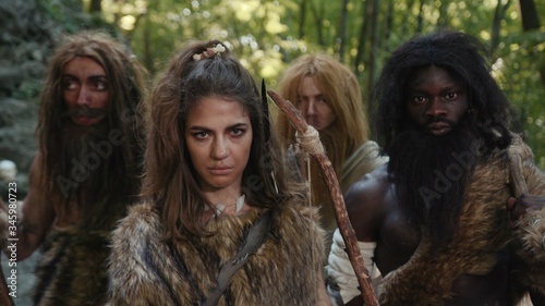 Cuadro en lienzo Primitive aboriginal tribe with female archer leader looking aggressively at camera