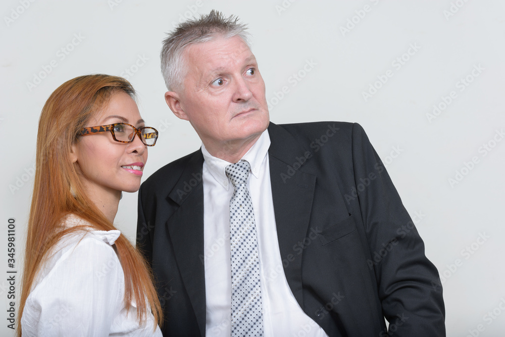 Happy mature multi ethnic business couple working together Happy mature multi ethnic business couple working together