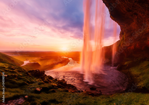 Impressive scenery of the majestic Icelandic waterfall Seljalandsfoss at sunset. Amazing landscape with dramatic picturesque sky.  Iceland the most beautiful and best travel place. Beauty of World