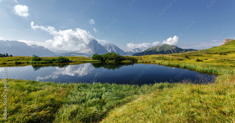 Awesome alpine highlands in summer in Dolomites Alps. Scenic image of famous Sassolungo peak. Splendid landscape in Val Gardena on a sunny day. Gorgeouse spring View of Alpine valley. Amazing summer