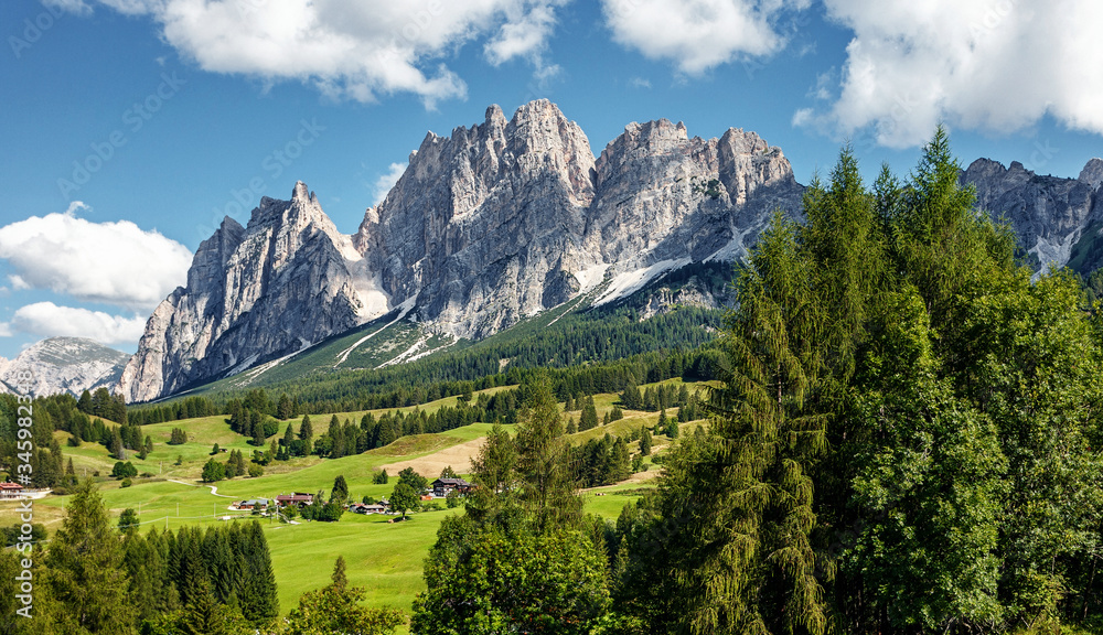 Green alpine valley with view of Italian Dolomites. Italian Alps,