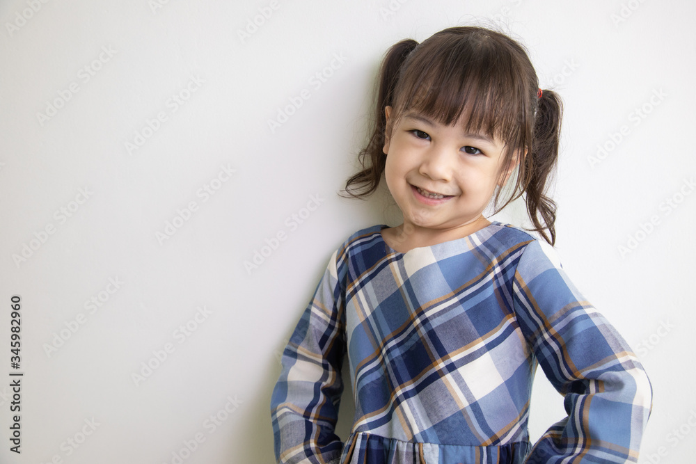 half-body and front-view photo of adorable, three-year-old Asian girl posing on a white background shows her brightness that makes people look happy, bright and cute. half-body and front-view photo of adorable, three-year-old Asian girl posing on a white background shows her brightness that makes people look happy, bright and cute.