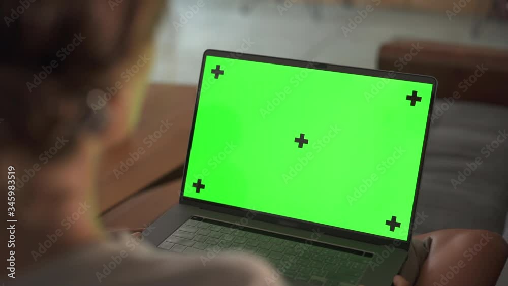 Zoom out from laptop Green Screen Mockup on girl hands sitting on sofa evening time