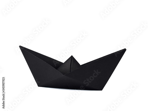 Origami black paper boat isolated on white background