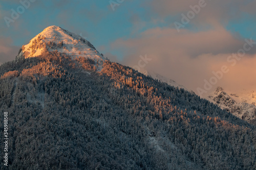 Mountain peak covered in early sunlight