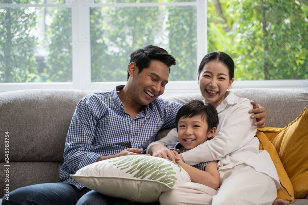 portrait of happy Asian family spending time together on sofa in living room. family and home concept. portrait of happy Asian family spending time together on sofa in living room. family and home concept.