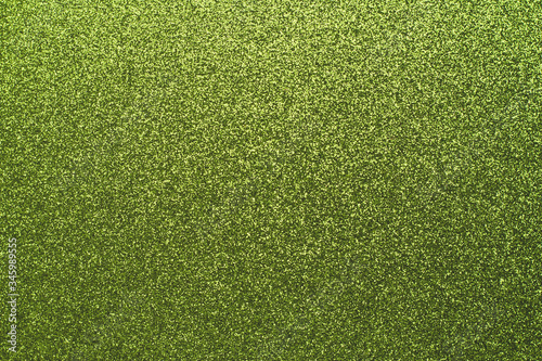 Green sparkly backgrounds, paper texture. Shiny foil surface, abstract wallpaper, backdrop. Holiday decoration design.