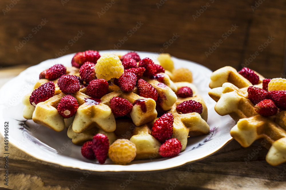 Homemade waffles with berries wooden background. Delicious, nutritious, fantastic breakfast or dessert. Soft focus Homemade waffles with berries wooden background. Delicious, nutritious, fantastic breakfast or dessert. Soft focus