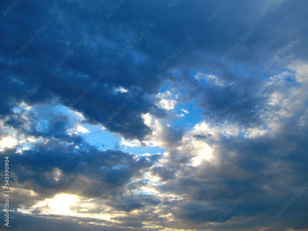 Fototapeta premium Dark clouds, illuminated by the sun.