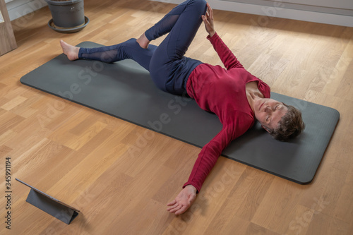 Gennevilliers, France - 05 03 2020: Woman doing yoga session at home
