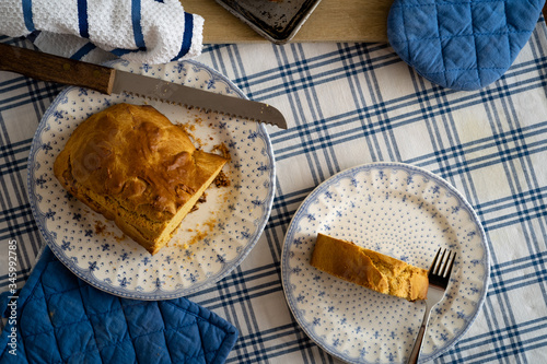 HOT HOME BREAD, ON A TABLE WITH TRADITIONAL TABLECLOTH