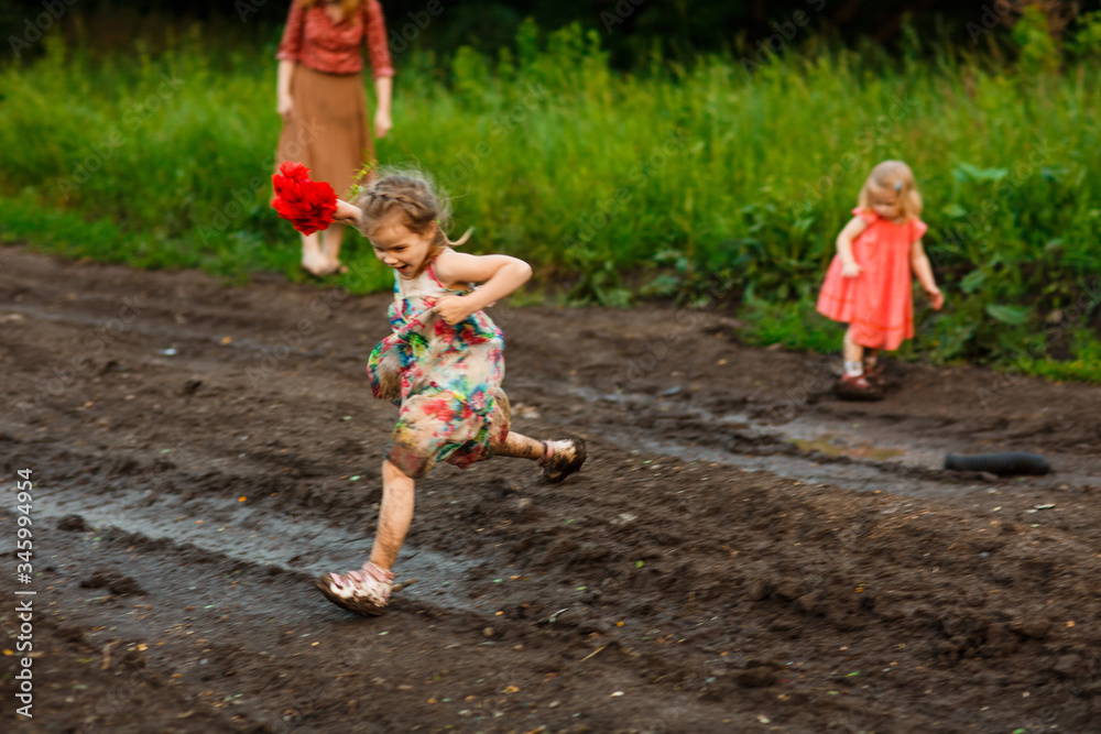kid jumping through puddle road after rain kid jumping through puddle road after rain