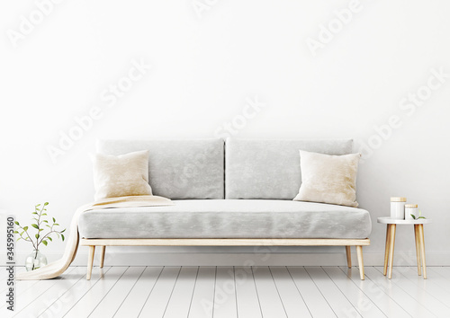 Interior wall mockup with gray velvet sofa, beige pillows and plaid, branch in vase and coffee table in living room with empty white wall background. 3D rendering, illustration.