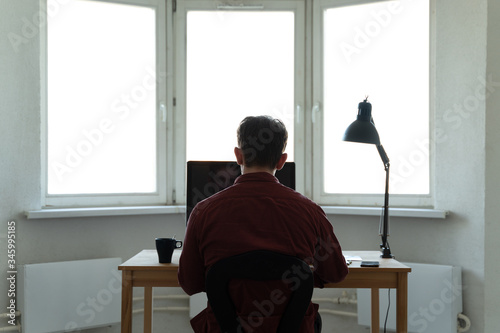 Young man working at the computer. Distance working, online education or shoping