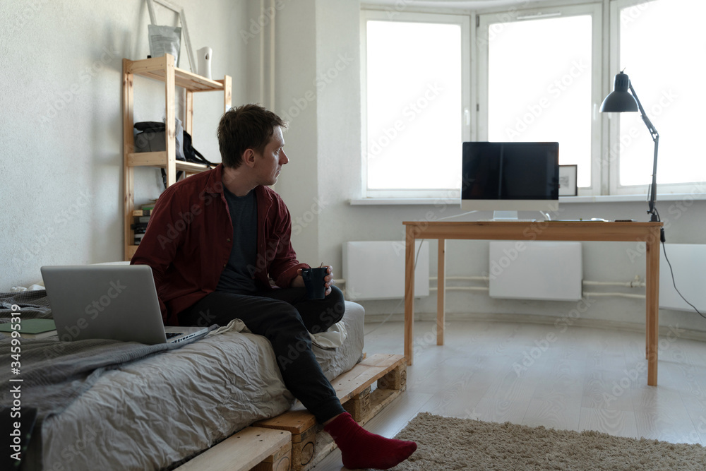 sad guy quarantined at home and looking out the window sad guy quarantined at home and looking out the window