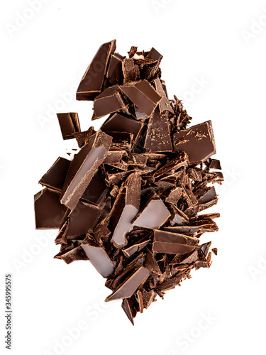 Falling Chocolate pieces and shavings isolated on white background.