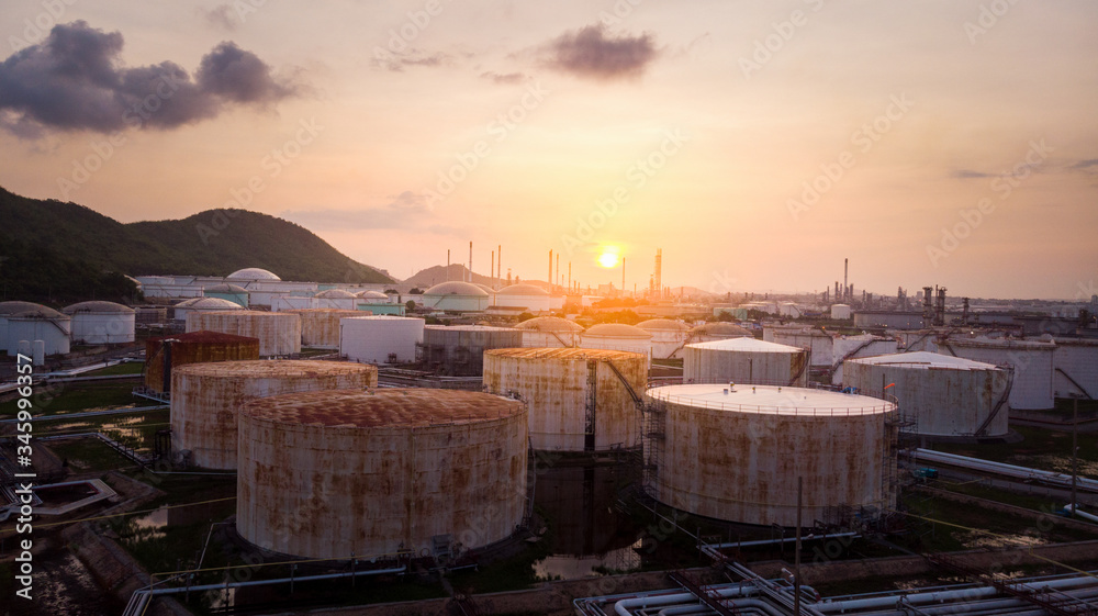 Fototapeta premium Aerial view of A lot of Oil depot Gas storage tank for send follow pipe to oil refinery tower on sunrise back ground.