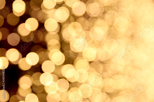 blurred golden circles of lights. defocused lights of festive garland