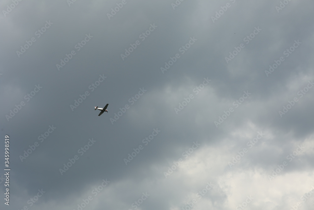 light aircraft in the sky with clouds