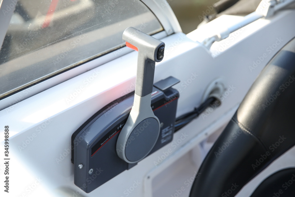 Fototapeta premium control lever of a white motor boat close up