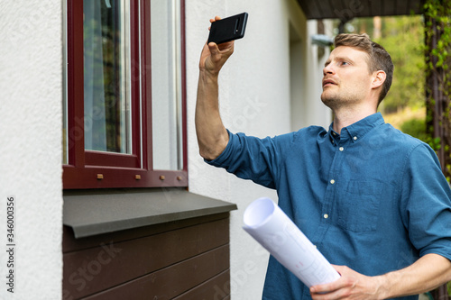 Canvas Print real estate appraiser taking pictures of property with phone