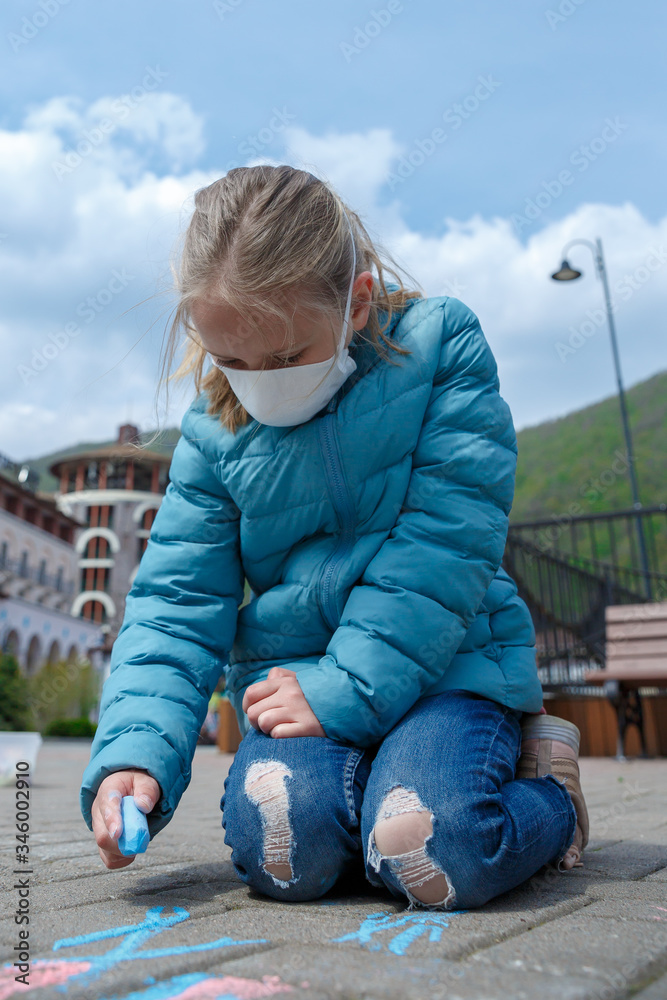 A little girl drawing with crayons wearing a medical mask, empty town on the background. A child in a protective mask. Warning of the dangers and safety quarantine measures against COVID-19
A little girl drawing with crayons wearing a medical mask, empty town on the background. A child in a protective mask. Warning of the dangers and safety quarantine measures against COVID-19