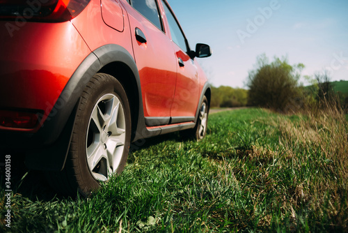 red car is staying on the grass