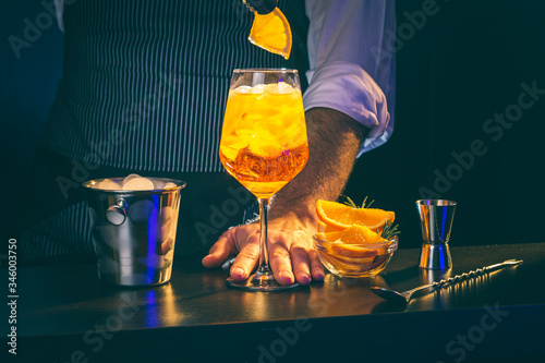 Bartender preparing Aperol Spritz cocktail photo