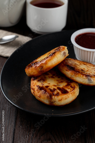 Close up of yummy traditional russian cottage cheese fritters with jam