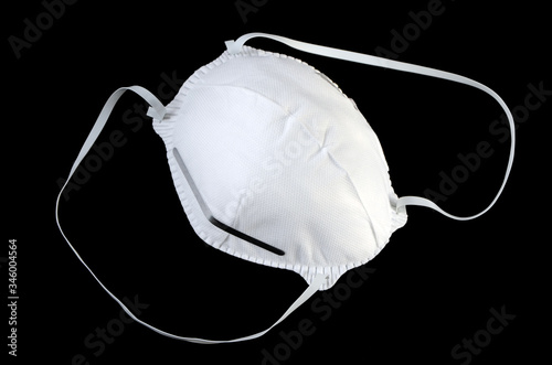 white protective mask isolated on black background photo