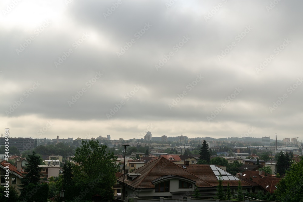 Sunrise and sunset, beautiful clouds over the meadow, hills and buildings in the town. Slovakia