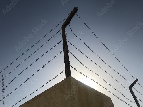 Steel barbed wire used an fencing work for more security or protection to avoid trespassers entry to zones photo