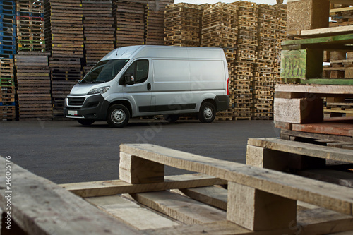 commercial freight van on the background of a pallet for packing goods and products photo