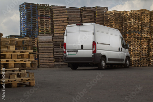 commercial freight van on the background of a pallet for packing goods