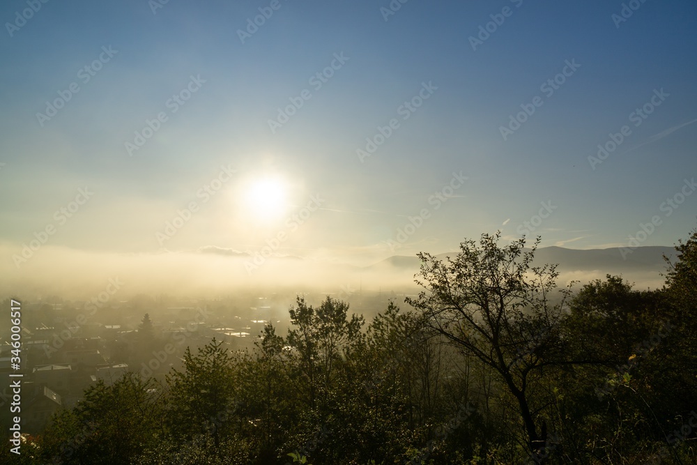 Sunrise and sunset, beautiful clouds over the meadow, hills and buildings in the town. Slovakia Sunrise and sunset, beautiful clouds over the meadow, hills and buildings in the town. Slovakia