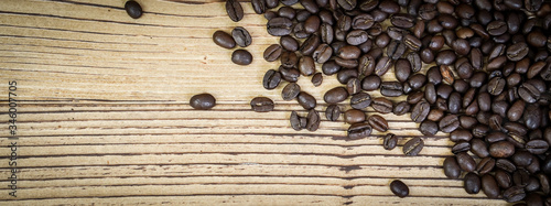 Banner fresh coffee beans on wooden table background.