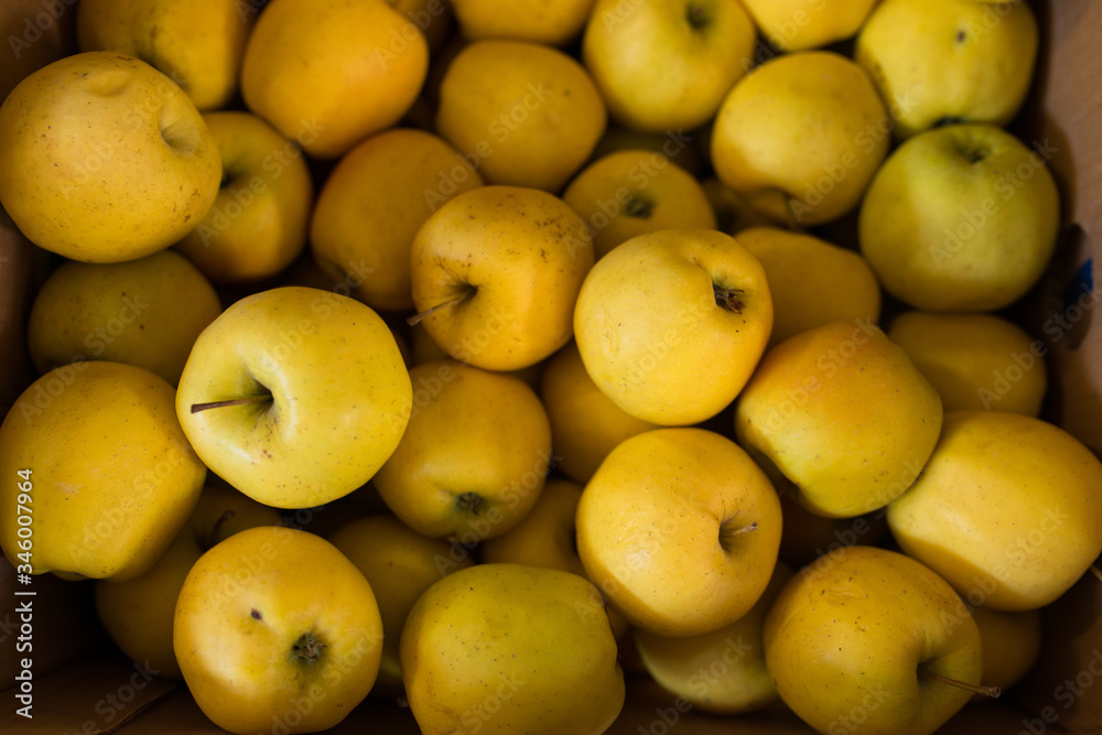Yellow apples in a crate in a store