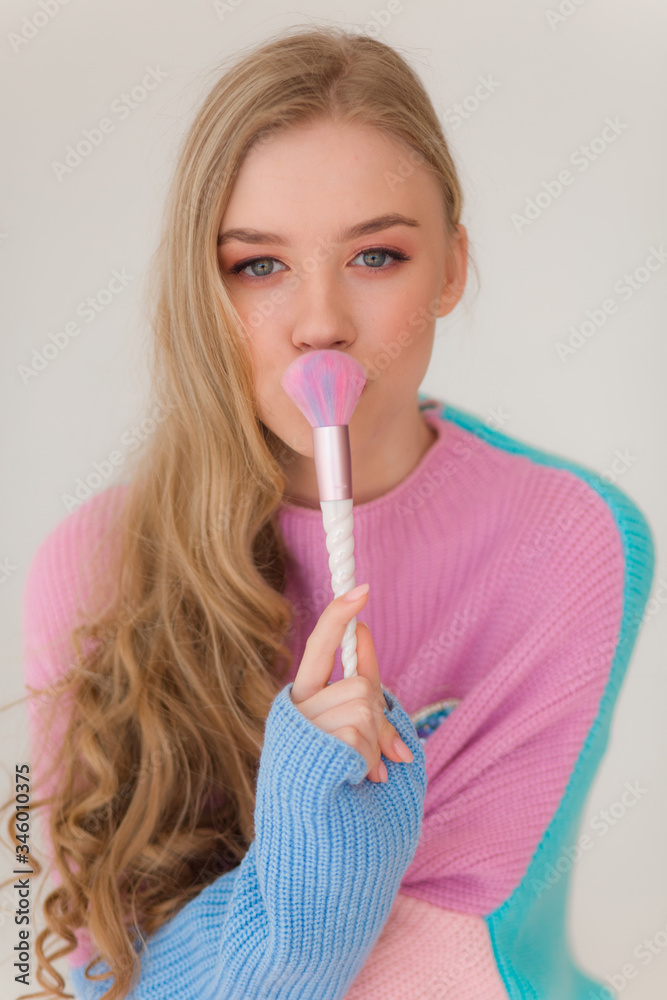 Portrait of beautiful young blonde girl with makeup in fashion clothes Portrait of beautiful young blonde girl with makeup in fashion clothes