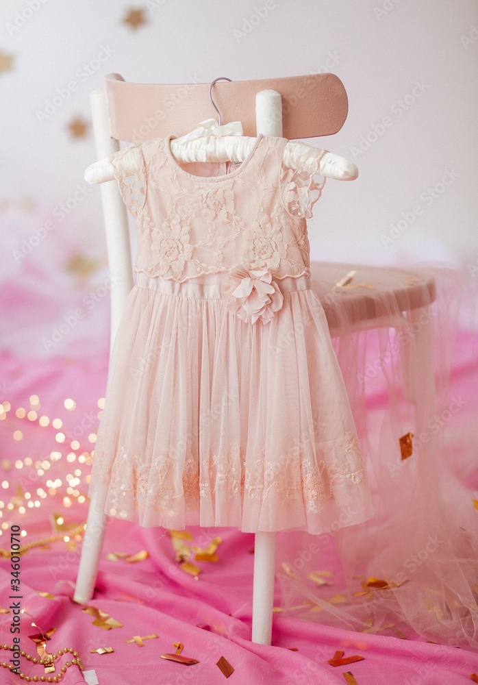 Stock Photo - Child dress on hanger on pink background Stock Photo - Child dress on hanger on pink background