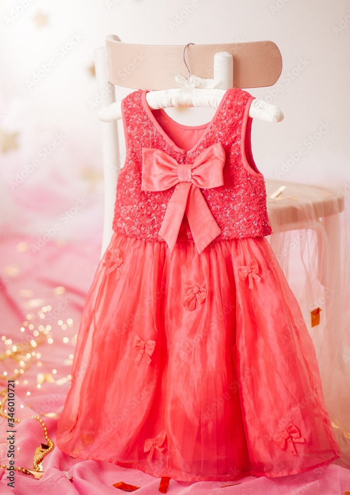 Stock Photo - Child dress on hanger on pink background Stock Photo - Child dress on hanger on pink background