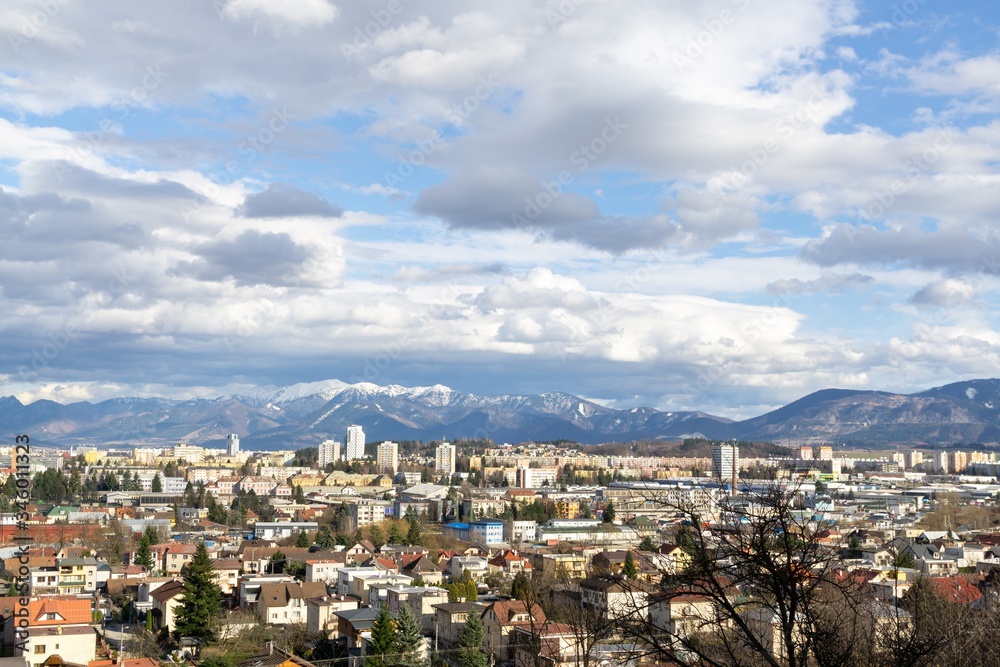 Sunrise and sunset, beautiful clouds over the meadow, hills and buildings in the town. Slovakia