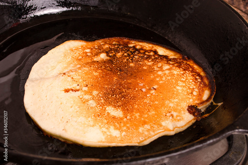 Close up of whole grain pancake on frying pan