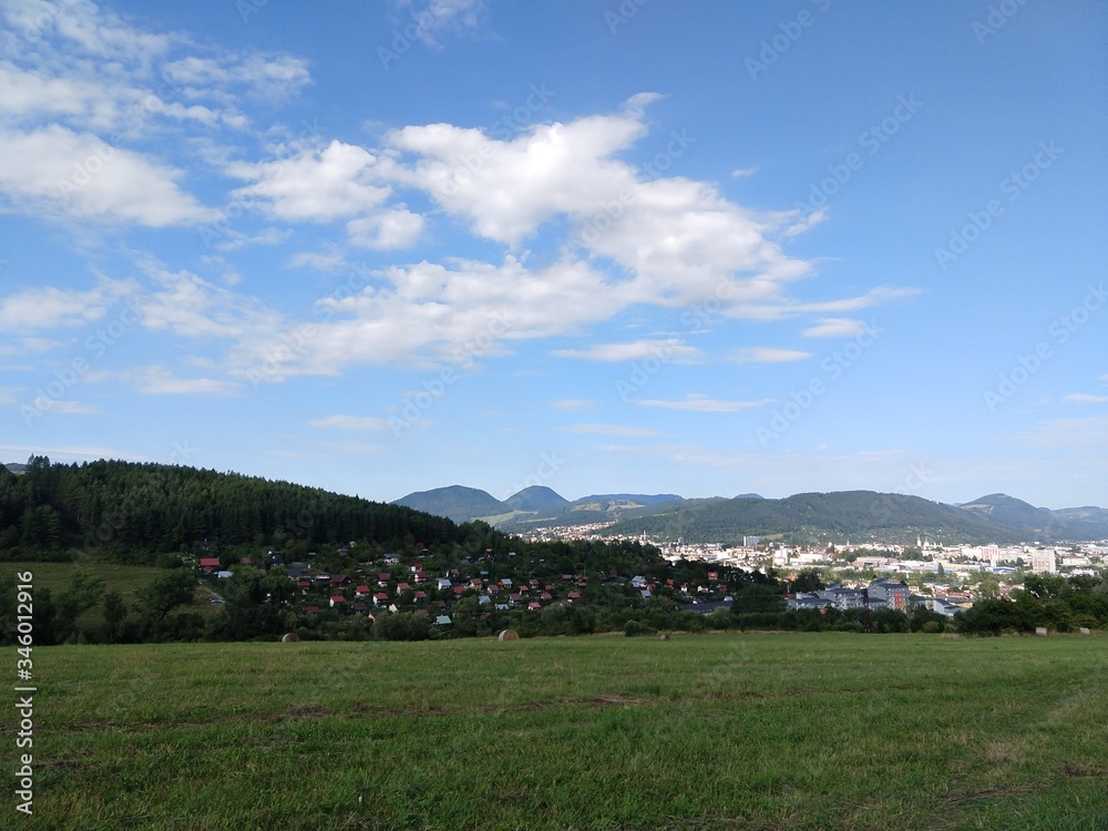 Sunrise and sunset, beautiful clouds over the meadow, hills and buildings in the town. Slovakia Sunrise and sunset, beautiful clouds over the meadow, hills and buildings in the town. Slovakia