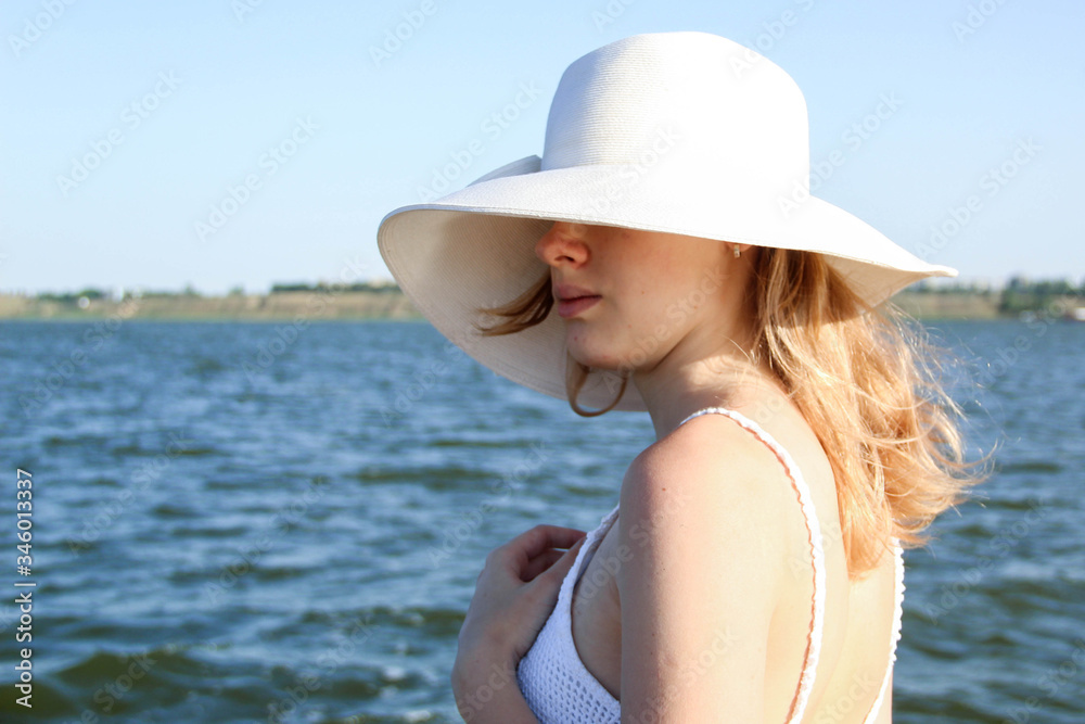 young woman in white hat