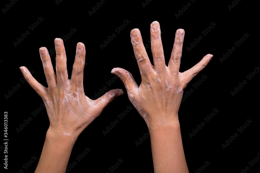 Hands in soap suds on a black background. Hands in soap suds on a black background.