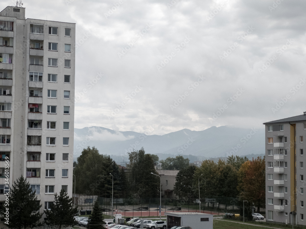 Sunrise and sunset, beautiful clouds over the meadow, hills and buildings in the town. Slovakia