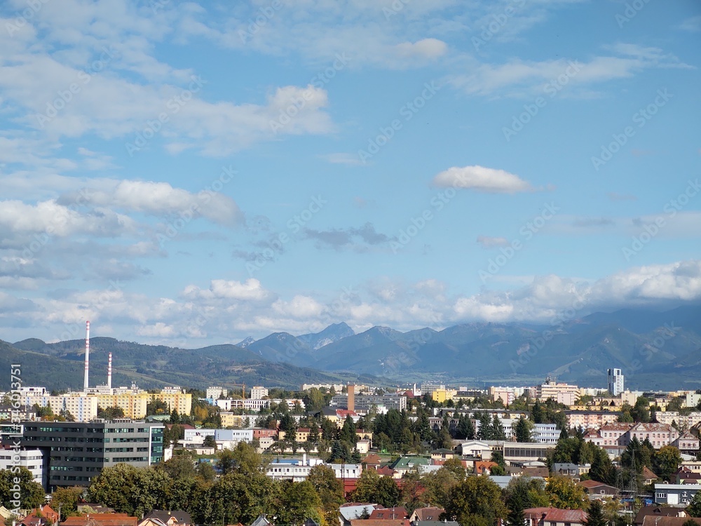 Obraz premium Sunrise and sunset, beautiful clouds over the meadow, hills and buildings in the town. Slovakia