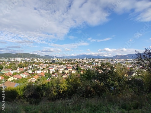 Sunrise and sunset, beautiful clouds over the meadow, hills and buildings in the town. Slovakia