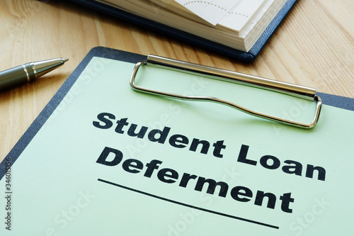 Student loan deferment application and clipboard. photo
