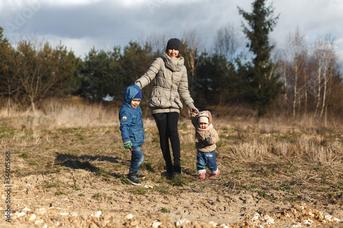 Wallpaper Mural Young mother with two children, a little girl and a boy who can go to the park for a photo shoot. Autumn family in the Park. Torontodigital.ca